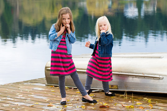 Two young girls stike a funny pose