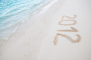 Numbers 2012 on tropical beach sand