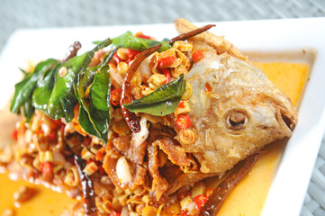 fried fish with fresh herbs and spicy