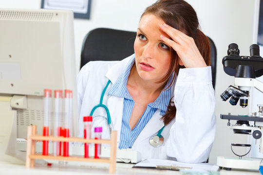 Concentrated doctor woman sitting in office