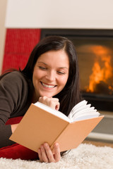 Naklejka premium Home fireplace happy woman read book winter
