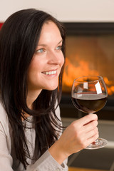 Winter home fireplace woman glass red wine