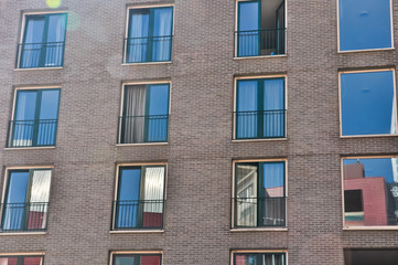 Fototapeta na wymiar wall with the windows of modern buildings