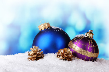 beautiful blue and purple Christmas balls and cones in snow
