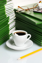 Many green folder with cup of coffee closeup