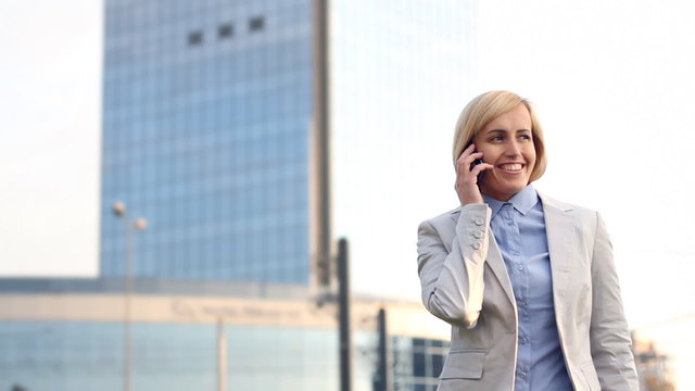 Attractive businesswoman talking on cellphone in the city