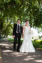 Naklejka premium Newlywed Young Couple Holding Hands