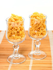 Macaroniin a glass on a straw mat