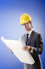Young architect with drawings and hardhat