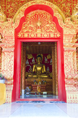 Golden Buddha in golden arch.