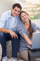 Portrait of a smiling couple using a notebook