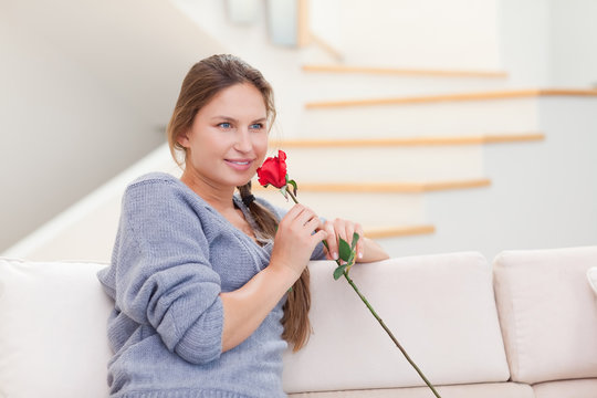 Young Woman Smelling A Rose