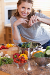 Obraz na płótnie Canvas Woman adding some spices to her meal
