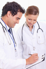 Fototapeta premium Assistant doctors taking notes