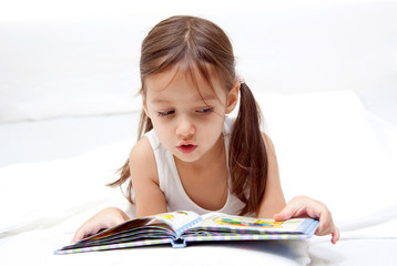 sweet little girl reading a book © Eva Vargyasi