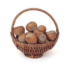 Wicker basket with hazelnuts isolated on a white background