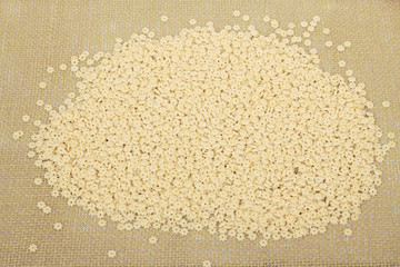 Pasta in the shape of an stars on brown cloth