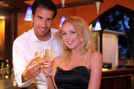 Couple drinking champagne in fancy bar
