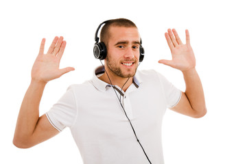 Casual young man enjoying listening music, isolated on white