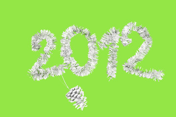2012 New Year's made of silver tinsel against a green