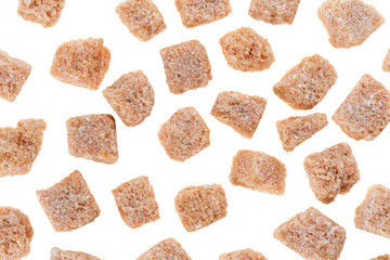 Many brown lump cane sugar cubes isolated on white, food backgro
