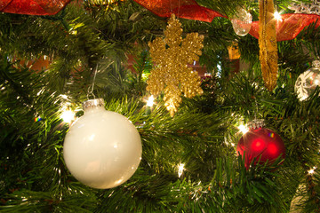 Ornaments, Lights and Ribbons on Bright, Green Christmas Tree