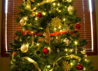 Ornaments, Lights and Ribbons on Bright, Green Christmas Tree