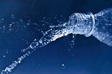 spray and drops of water from plastic bottles