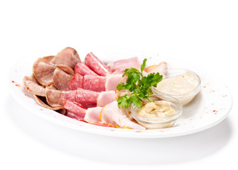 Meat delicatessen plate with souce