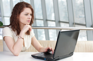Fototapeta na wymiar Young business woman with laptop