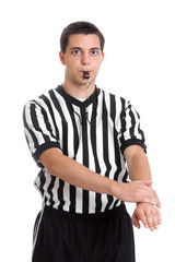 Teen basketball referee giving defensive foul sign