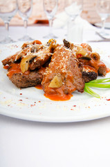 Meat served with sauce in the plate