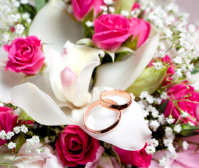 Gold wedding rings on flower