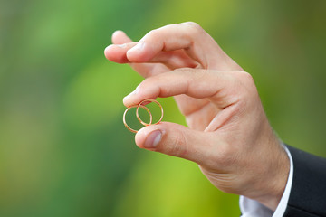 Gold wedding rings on a hand of the groom
