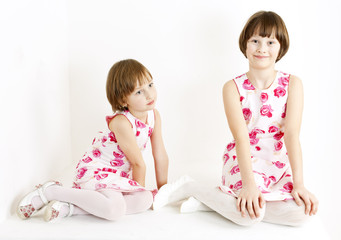 two sisters wearing similar dresses