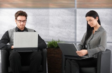Young businesspeople using laptop