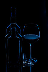 silhouette of bottles with glass of wine