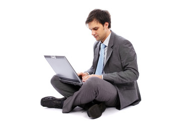 Young businessman typing on a laptop