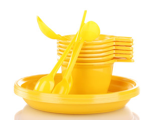 Bright yellow plastic tableware isolated on white