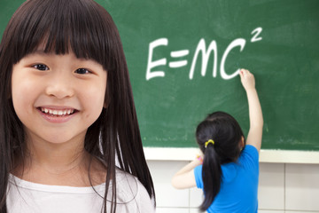 happy girls  by chalkboard with e=mc2