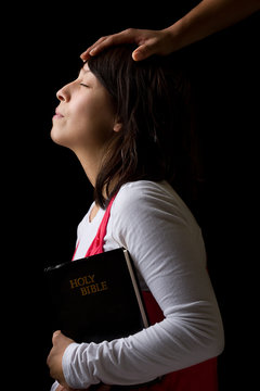 Hispanic Woman Being Blesses While Praying