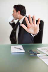 Portrait of a businessman not willing to be disturbed while drin