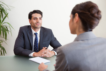 Handsome manager interviewing a female applicant