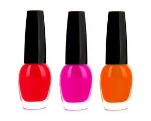 Nail polish of red, pink and orange color isolated on white