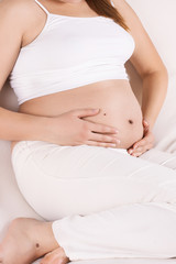 Fototapeta na wymiar pregnant woman touching her tummy