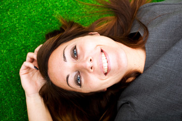 Fototapeta premium Beautiful woman laying on the grass