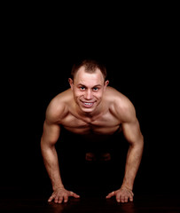Fototapeta na wymiar Athletic muscular man do exercise