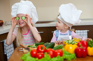 two little girls preparing healthy food on kitchen