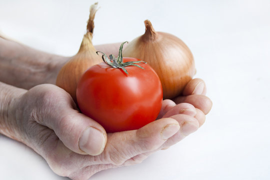 Tomato And Onions In Old Hands