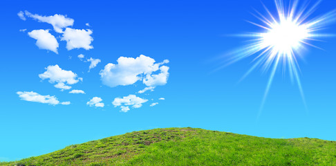 Obraz na płótnie Canvas Green grass hills under midday sun